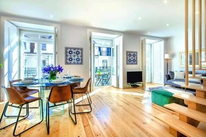 Dining table with chairs and sofa living room at Rua da Prata in Lisbon Student Accommodation