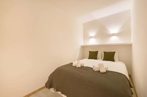 Bed with pillows towels and blanket bedroom at 2-bedroom apartment in Rua Artur Lamas 12, Lisbon in Lisbon Student Accommodation