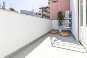 Rattan poufs plant air conditioners Balcony at Apartment in Lisbon with 56 m² and 1 bedroom in Lisbon Student Accommodation