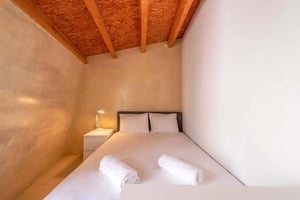 Bed pillows bedside lamp and white towels bedroom at Room in Rua Poiais de São Bento, Lisboa for 162 m² with 6 bedrooms in Lisbon Student Accommodation