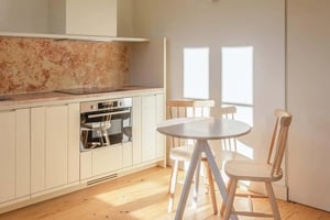 Table chairs oven cabinets kitchen area at Armada IV in Lisbon Student Accommodation