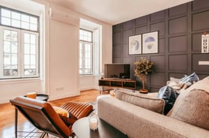 Sofa chair TV artwork plant and windows living room at Chic & Elegant Lapa in Lisbon Student Accommodation