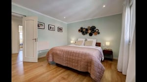 Quilted bed wall art pictures and lamp bedroom at Comfortable Town House in Quiet Area in Lisbon Student Accommodation