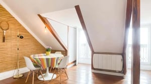 Table with chairs radiator and tennis racket dining area at Apartment in Rua da Rosa, Lisboa for 86 m² with 1 bedroom in Lisbon Student Accommodation