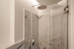 Marble shower with chrome fixtures and glass enclosure bathroom at Apartment in Avenida António Augusto de Aguiar, Lisboa for 53.8 m² with 1 bedroom in Lisbon Student Accommodation