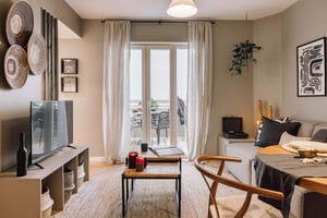 Living room with sofa tv and dining table living room at 2 bedrooms in Lapa in Lisbon Student Accommodation
