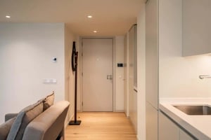 Sofa, coat rack, and kitchen counter visible Living room at Apartment in Parque das Nações, Lisboa for 48 m² with 1 bedroom in Lisbon Student Accommodation