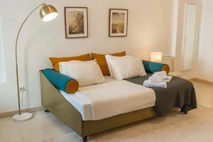 Daybed with pillows artwork lamp towels bedroom at Apartment in Rua da Bombarda, Lisbon - unit 34 in Lisbon Student Accommodation