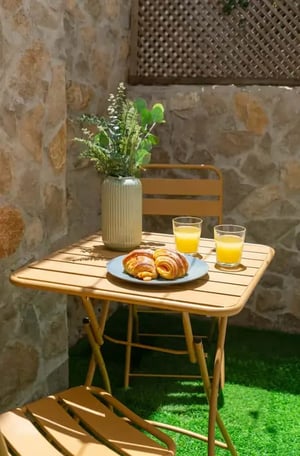 Table with croissants and juice outdoor dining area at 2BDR Apartment with private terrace in Rua da Bombarda, Lisbon - unit 102 in Lisbon Student Accommodation