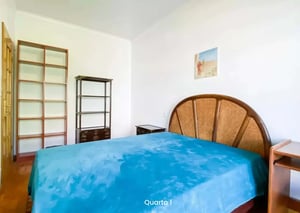 Bed with blue covers shelving and bedside table bedroom at Room in Avenida Gomes Pereira, Lisboa - Room 1 - 5D floor in Lisbon Student Accommodation