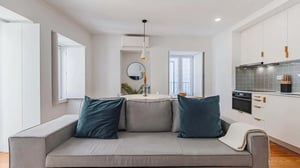 Gray sofa with blue and gray pillows living room at Pescadores House 2 Dto in Lisbon Student Accommodation