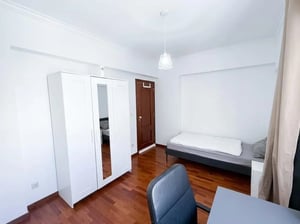 White wardrobe bed desk chair wooden floor bedroom at Room in Rua Conselheiro Lopo Vaz, Lisboa with 4 bedrooms in Lisbon Student Accommodation