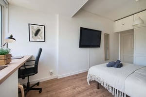 Desk chair television bed and door bedroom at Charming Studio in Avenida Infante Santo, Lisbon in Lisbon Student Accommodation