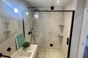 Glass shower modern sink letter board plant bathroom at Spacious Apartment in Avenida Afonso Costa, Lisboa for 102 m² with 3 bedrooms in Lisbon Student Accommodation