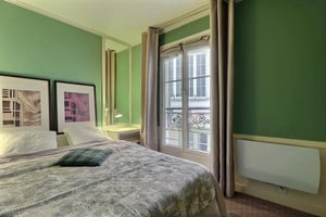 Bed with plaid pillow and art bedroom at Apartment in Rue Saint-Honoré, 75001 Paris, France in Paris Student Accommodation