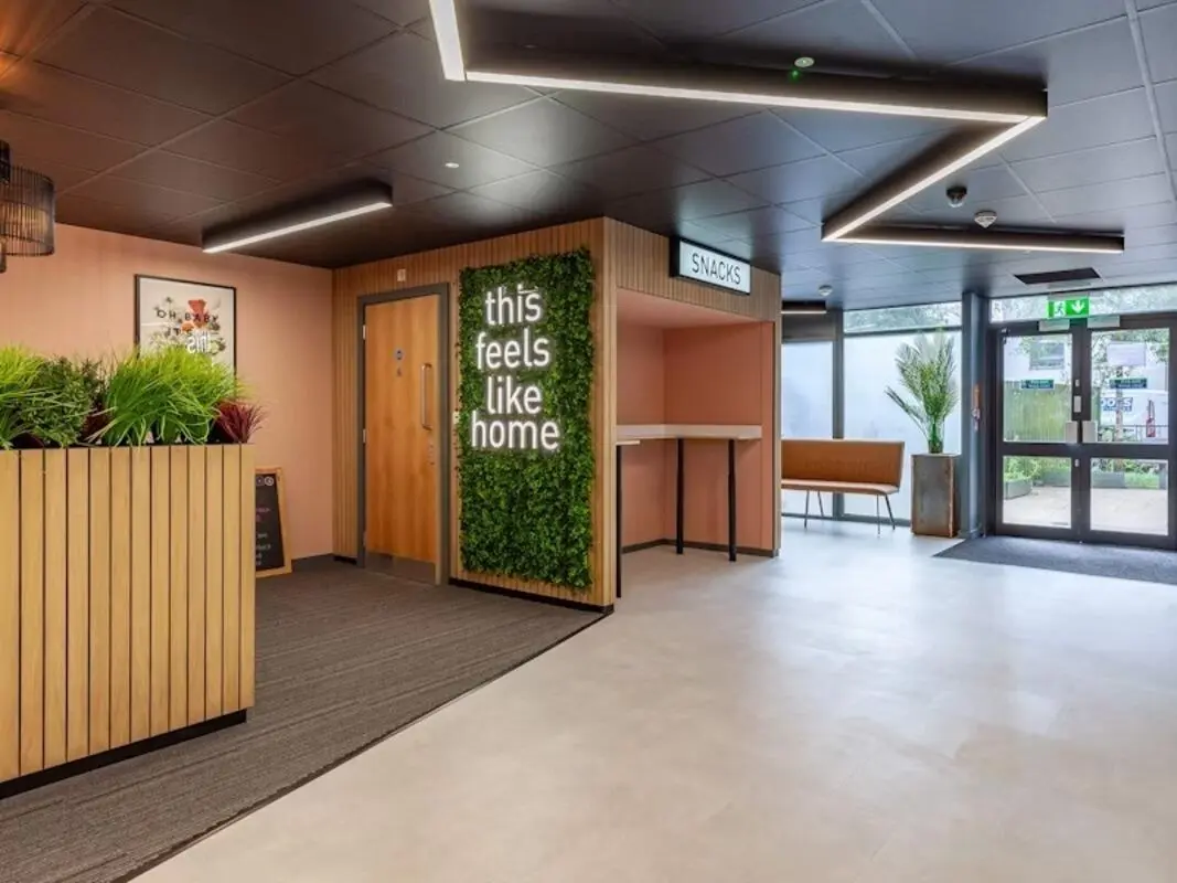 Interior lobby with plants snacks counter and seating area interior at Filbert Village in Leicester Student Accommodation