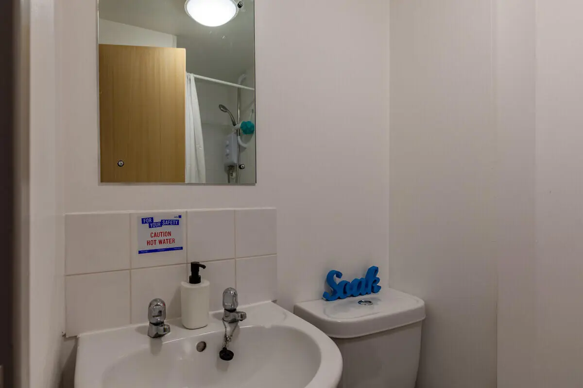 Sink toilet mirror shower curtain bathroom at Filbert Village in Leicester Student Accommodation