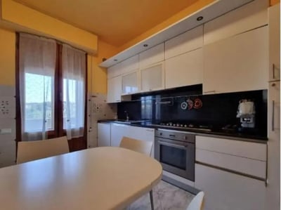White cabinets oven and dining table kitchen at Single Bedroom in a Shared Apartment in Siena Student Accommodation