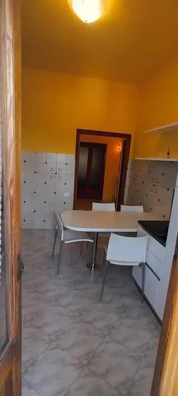 Dining table with chairs in kitchen area at Single Bedroom with Balcony in Siena in Siena Student Accommodation