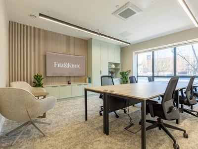 Modern meeting room with table chairs and TV at Fitz and Knox in Cardiff Student Accommodation