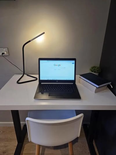 Desk with laptop lamp books and chair study area at Sydney Student Living Top Ryde in Sydney Student Accommodation