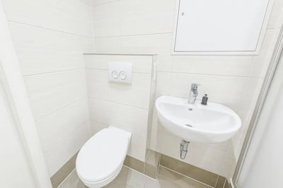 White toilet sink and chrome faucet bathroom at Welcoming studio in Grünau-Nord in Leipzig Student Accommodation