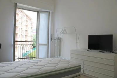 Bed dresser TV clothes rack bedroom at Pleasant single bedroom in Santa Lucia in Bergamo Student Accommodation