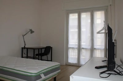 Mattress desk chair lamp TV bedroom at Comfy single bedroom in Santa Lucia in Bergamo Student Accommodation