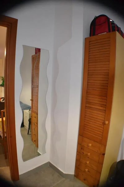 Wardrobe with bag mirror and doorway Bedroom at Appartamento di due camere da letto in Turin Student Accommodation
