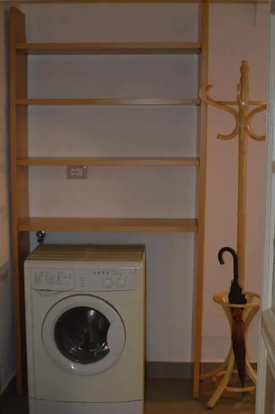 Shelving washing machine coat rack umbrella stand utility area at Appartamento di due camere da letto in Turin Student Accommodation