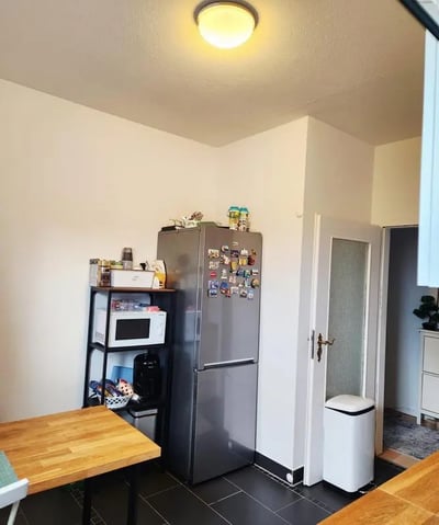 Refrigerator microwave shelf and dining table kitchen at Inviting double bedroom in a 4-bedroom apartment, in the Reinickendorf neighbourhood in Berlin Student Accommodation