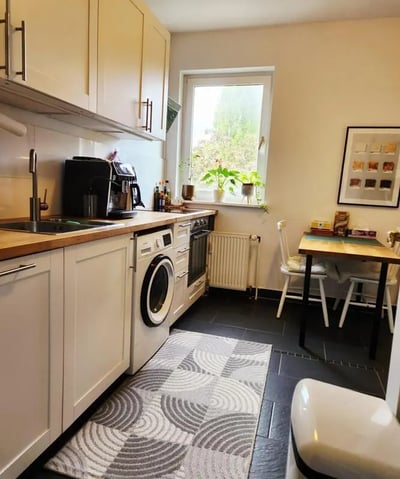 Sink washing machine cabinets table chairs kitchen at Inviting double bedroom in a 4-bedroom apartment, in the Reinickendorf neighbourhood in Berlin Student Accommodation