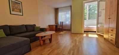 Sofa coffee table desk chair closet balcony living room at Bright 1-bedroom apartment close to the Richard-Wagner-Platz metro station in Berlin Student Accommodation