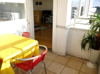 Yellow tablecloth red chairs balcony plant exterior at Neat 2-bedroom flat in Schöneberg in Berlin Student Accommodation