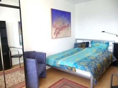 Two beds armchairs artwork bedroom at Neat 2-bedroom flat in Schöneberg in Berlin Student Accommodation