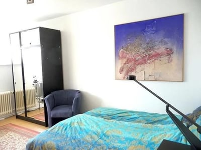 Wardrobe chair and beds with art bedroom at Neat 2-bedroom flat in Schöneberg in Berlin Student Accommodation