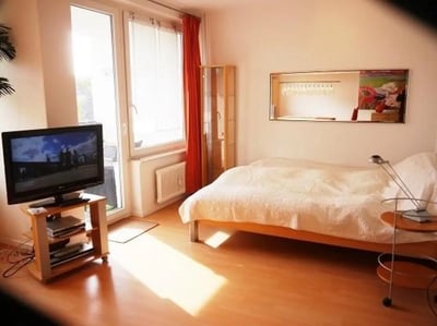 Bed TV cabinet and artwork bedroom at Admirable and bright studio in Charlottenburg in Berlin Student Accommodation