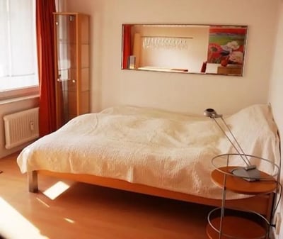 Bed lamp cabinet window radiator and painting bedroom at Admirable and bright studio in Charlottenburg in Berlin Student Accommodation