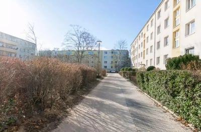 Apartment buildings with bushes and path exterior at Cozy single bedroom in a 4-bedroom apartment in Aldershof in Berlin Student Accommodation