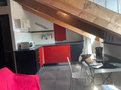 Red cabinets microwave and dining table kitchen area at Great-looking studio near Università degli Studi di Torino in Turin Student Accommodation
