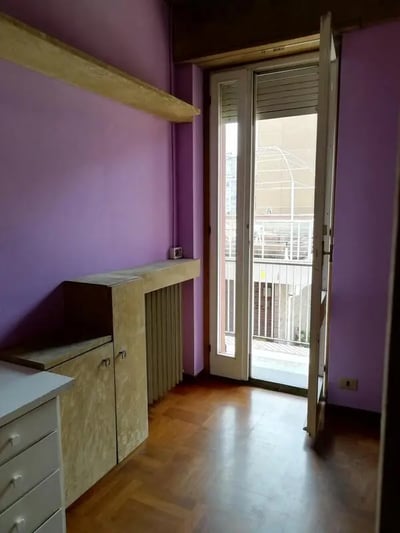 Purple walls wooden floor built-in cabinet room at Single bedroom "fil rouge", with balcony, in 5-bedroom apartment in Turin Student Accommodation