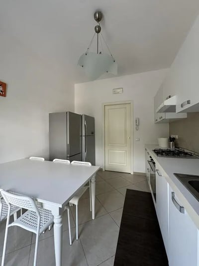 White dining table refrigerators and kitchen area kitchen at Neat single bedroom in the heart of Verona in Verona Student Accommodation