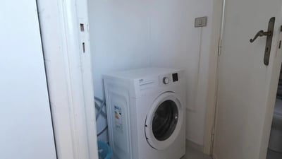 White washing machine in a utility room at Bright single bedroom in Cappuccini in Sassari Student Accommodation