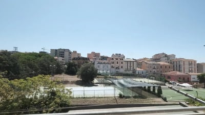 Tennis courts with green outdoor playing areas exterior at Bright single bedroom in Cappuccini in Sassari Student Accommodation