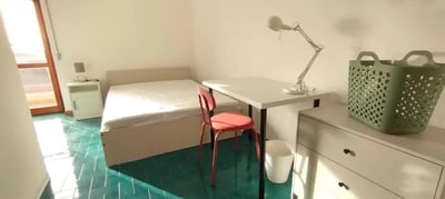 Bed desk chair lamp and basket bedroom at Bright single bedroom in Cappuccini in Sassari Student Accommodation