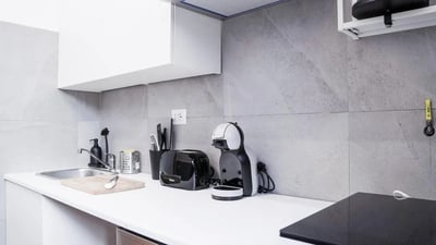 Sink toaster coffee machine and cutting board kitchen at Cozy single bedroom in welcoming flat in Pigneto in Rome Student Accommodation