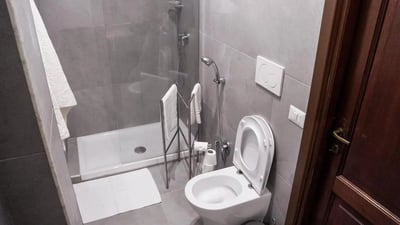 Toilet shower towels towel rack bathroom at Cozy single bedroom in welcoming flat in Pigneto in Rome Student Accommodation