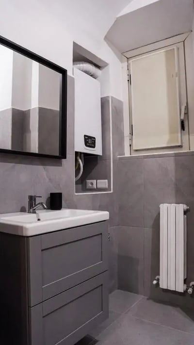 Gray vanity sink mirror and radiator bathroom at Cozy single bedroom in welcoming flat in Pigneto in Rome Student Accommodation