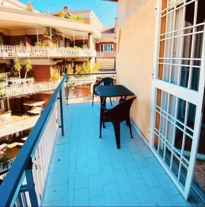 Table and chairs on tiled balcony exterior at One-Bedroom Apartment in Rome in Rome Student Accommodation