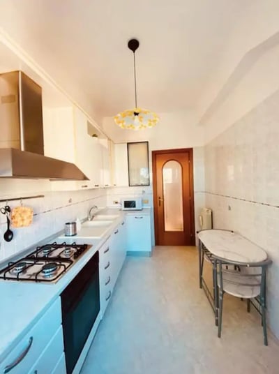 Kitchen with stove sink microwave and table kitchen at One-Bedroom Apartment in Rome in Rome Student Accommodation